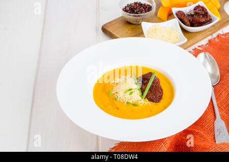 Delicious spicy pumpkin soup with parmesan. Studio Photo Stock Photo