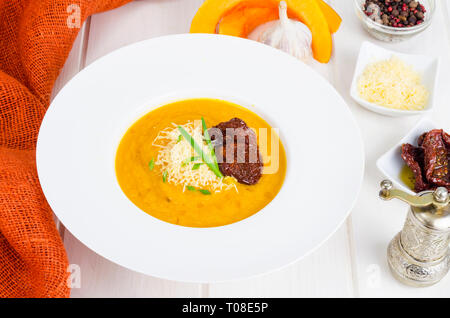 Delicious spicy pumpkin soup with parmesan. Studio Photo Stock Photo