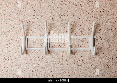 White Clothes hanger on a wall background Stock Photo