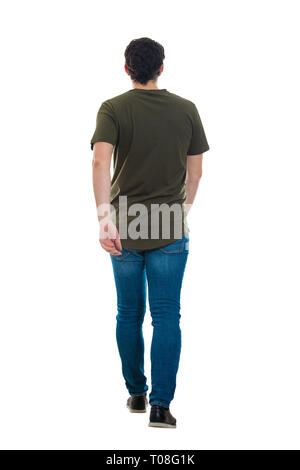 Full length rear view of casual young man confident fast walking isolated over white background. Motion shot making a step going ahead hurried. Stock Photo