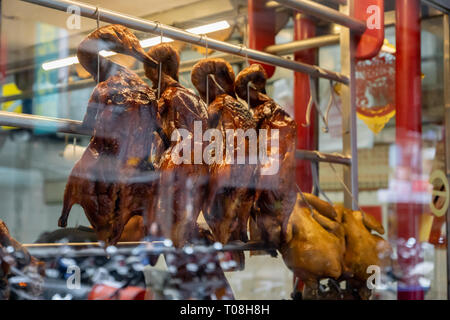 Roasted Peking ducks hanging in front of Chinese restaurant Stock Photo