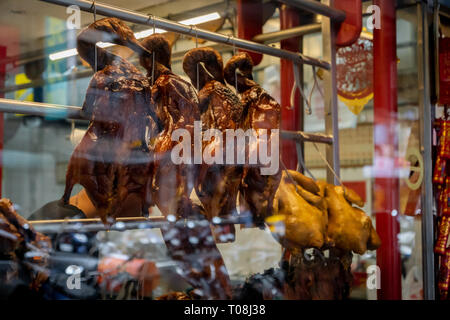 Roasted Peking ducks hanging in front of Chinese restaurant Stock Photo