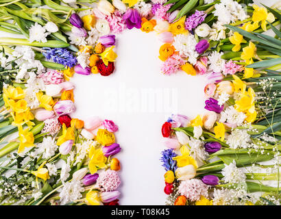 Flowers and cross Easter abstract concept on a white background. Copy space. Stock Photo