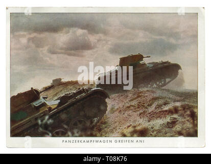 German historical postcard: Light tanks Panzer PzKpfw I with paired machine guns in the towers overcome an earthen obstacle against the dark blue sky Stock Photo