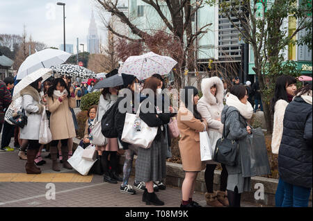31.12.2017, Tokyo, Kanto, Japan - Young women line up in front of a shop in the Shibuya district to meet a prominent personality. 0SL171231D062CAROEX. Stock Photo