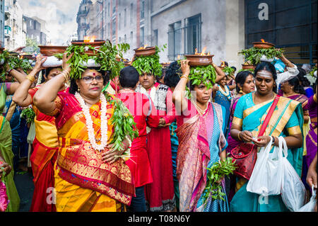 Upon Ganesh Chaturthi festival in Paris, female dancers wearing colorful saris, carry on their heads terracotta pots with burning camphor. Stock Photo