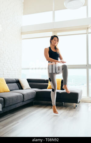 Adult Woman Training ABS and Legs Doing High Knee Tap Stock Photo