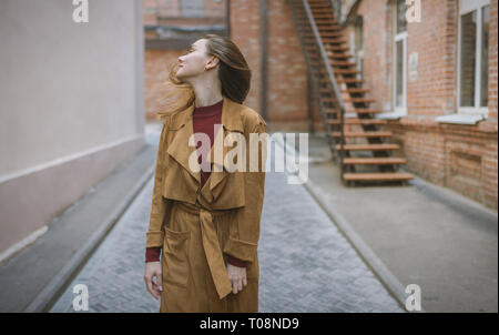 Woman in vintage cloak at street. Stock Photo