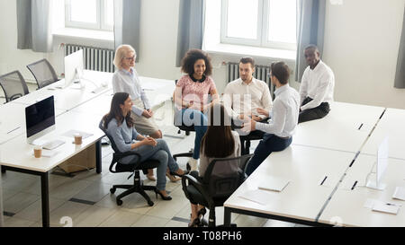 Male coach mentor speaking at corporate group meeting, top view Stock Photo