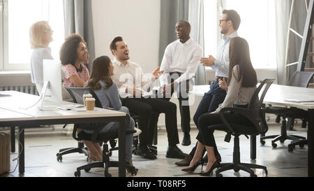 Happy diverse business team employees having fun at corporate meeting Stock Photo