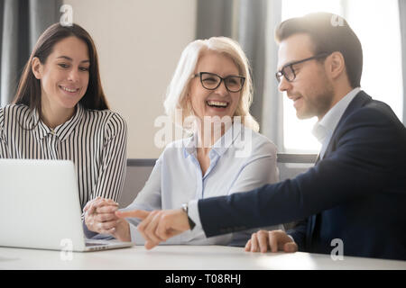 Happy business team people colleagues talking laughing working together Stock Photo