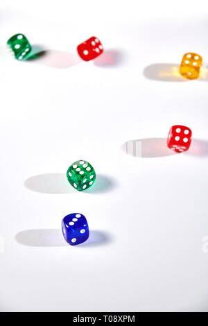 colorful dices in motion on white background Stock Photo