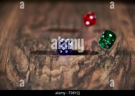 colorful dices in motion on wooden background Stock Photo