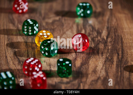colorful dices in motion on wooden background Stock Photo