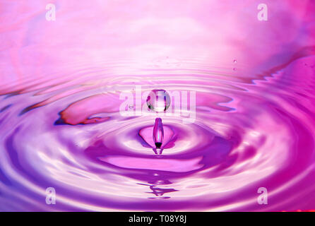 drop in water makes different splashes Stock Photo
