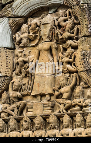 Standing devata (female deity) & dancing apsaras (heavenly nymphs) at 12thC Khmer temple Ta Prohm; Angkor, Siem Reap, Cambodia. Stock Photo