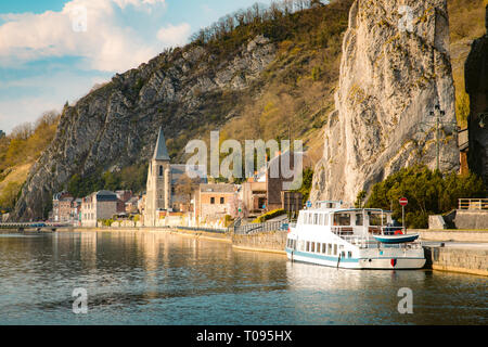 Panoramic view of scenic Meuse river with famous Bayard Rock and the historic town of Dinant in the background in beautiful golden evening light at su Stock Photo