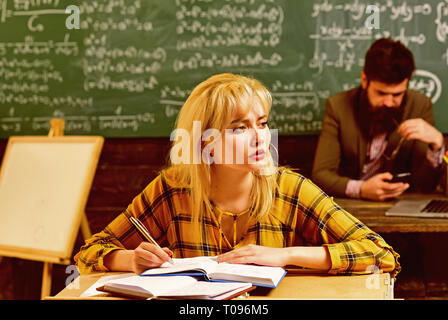 Teacher puts marks sends feedbacks on email with laptop computer. International student making individual online testing and writing composition for Stock Photo