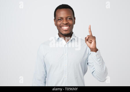 African young man showing index fingers up, giving advice Stock Photo