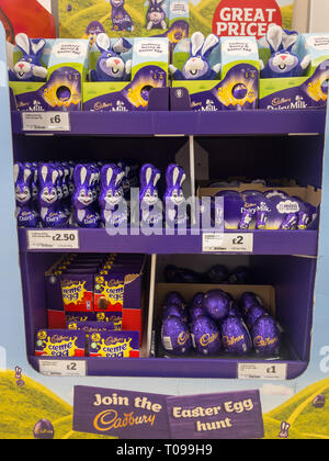 Exeter, Devon , England, March, 14, 2019: A supermarket in the UK end cap, selling chocolate Easter Eggs, chocolate Easter Bunnies. Lots of purple in  Stock Photo