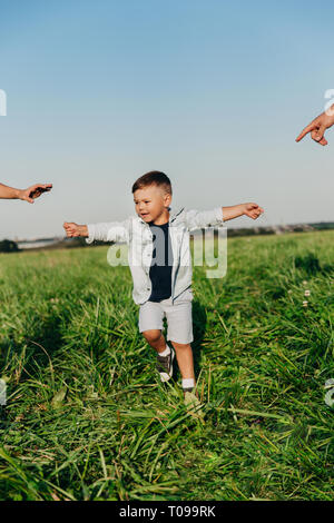 Little boy want to hold hands his parents outdoor. Stock Photo
