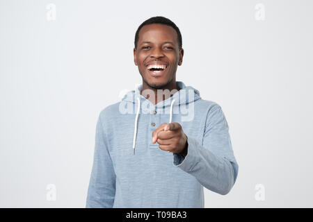 African excited young man pointing at you joking having fun Stock Photo