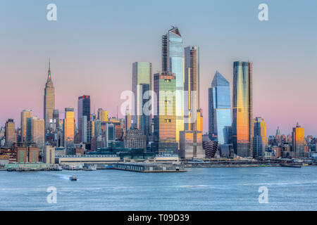 The mixed-use Hudson Yards real estate development and other buildings on the West Side of Manhattan in New York City at sunset. Stock Photo