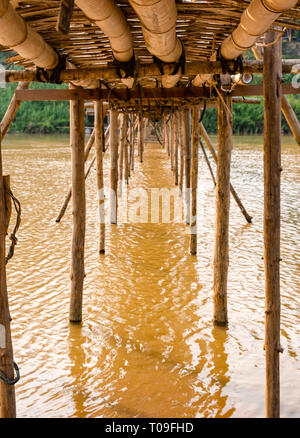 View under bamboo cane bridge over Nam Kahn river tributary of Mekong, Luang Prabang, Laos, Indochina, SE Asia Stock Photo