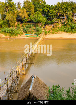 Rickety bamboo cane bridge over Nam Kahn river tributary of Mekong, Luang Prabang, Laos, Indochina, SE Asia Stock Photo