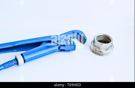 Gas adjustable wrench and large nut for water supply. Metalware tools isolated on a light background. Stock Photo