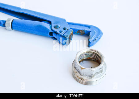 Gas adjustable wrench and large nut for water supply. Metalware tools isolated on a light background. Stock Photo