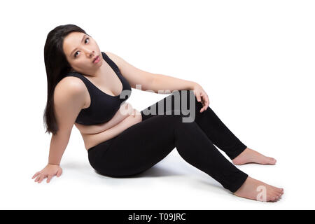 lazy fat woman bored face tired exhausted to exercise weight loss sitting on ground isolated on white background Stock Photo