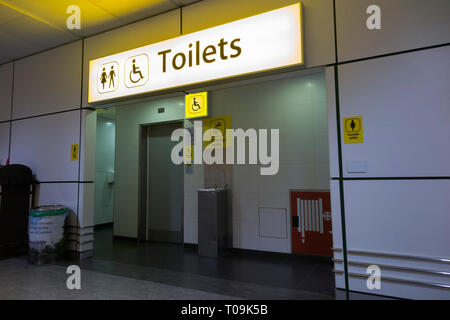 Water Fountain and public toilet / toilets / lavatory/ lavatories for male, female, men, and women, as well as disabled people and parents of young children, in the baggage reclaim area at North Terminal , Gatwick airport. London. UK. (104) Stock Photo