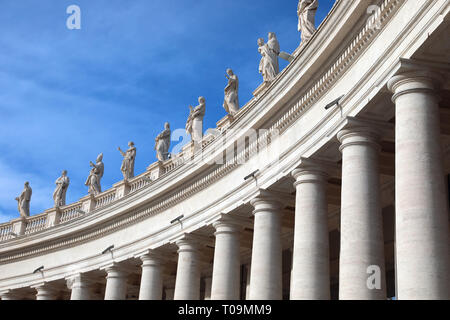 white columns and statues above the colonnade of the architect Bellini in the Saint Peter Square in the Vatican City in Central Italy Stock Photo