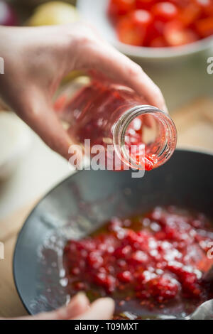 Preparing raspberry vinaigrette dressing Stock Photo