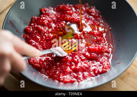 Preparing raspberry vinaigrette dressing Stock Photo