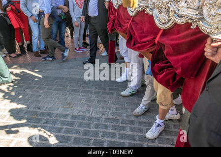 SEVILLE, SPAIN - MARCH 26:  View of the feet of people as they carry a float during a religious procession during Holy Week in Seville, Spain on March Stock Photo