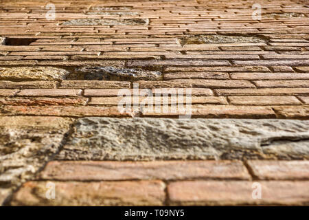 An stone wall of a building from the ground prespective looking up. brick wall Stock Photo