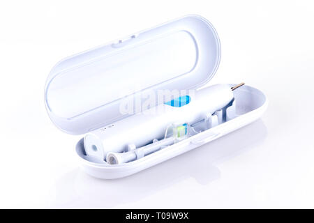 Ultrasonic toothbrush in travel box isolated on a white background with reflection and copy space. Dental concept. - Image Stock Photo