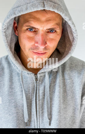 portrait of a man in gray hooded shirt Stock Photo