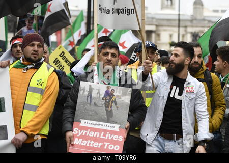 London, Greater London, UK. 16th Mar, 2019. A protester seen holding a placard that says Syrian lives matter too during the 8th Anniversary of the Syrian Revolution protest.Syrians marched from Paddington Green to Whitehall to demand for a peaceful solution of the war in Syria and restore democracy, they also call for an end of forced displacement, war crimes and foreign occupation in the country. Credit: Andres Pantoja/SOPA Images/ZUMA Wire/Alamy Live News Stock Photo