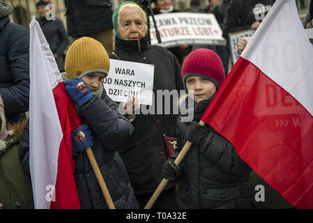 Warsaw, Poland. 18th Mar, 2019. Children are seen holding a Polish flags during the protest.Today outside the Warsaw's town hall, parents of primary and secondary school pupils protested against the new 12-point LGBT  rights declaration signed by the new Mayor Rafal Trzaskowski. Credit: ZUMA Press, Inc./Alamy Live News Stock Photo