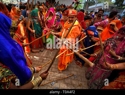 Mathura, Uttar Pradesh, India. 18th Mar, 2019. Hindu devotees are seen playing with sticks called Chaddi during the Holi Festival celebration at Gokul Dham, Mathura. This event is popularly named as Chaddimar Holi where women beat men with little sticks as per Traditional culture of Gokul, Gokul is the birth place of Hindu Lord Krishna who used to play HOLI with his friends like this way as per Local belief. Credit: Avishek Das/SOPA Images/ZUMA Wire/Alamy Live News Stock Photo