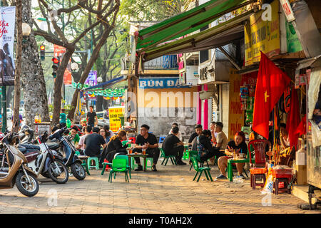 Young students having coffee and drinks at a street cafe, Old Quarter, Hanoi, Vietnam, Asia Stock Photo