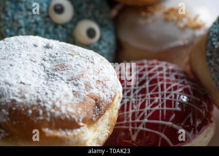 Delicious freshly baked Berliner with various toppings Stock Photo