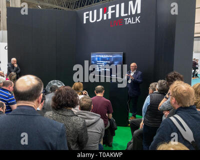 The Photography Show, Birmingham, UK, March, 17, 2019: Brian Lloyd Duckett presenting to a packed audeince at the Fujifilm stand at The Photography Sh Stock Photo
