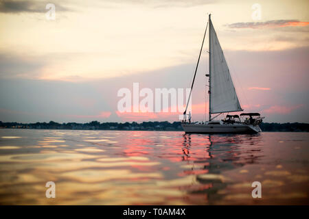 Happy young couple standing on the deck of a boat. Stock Photo
