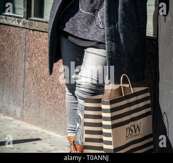 A shopper with her DSW shopping bag in Chelsea in New York on