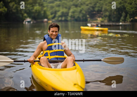 Portrait of a smiling man sitting in kayak. Stock Photo