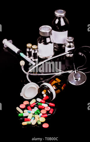 Medical capules, vials for injection with a syringe and ampules on black background - Image Stock Photo